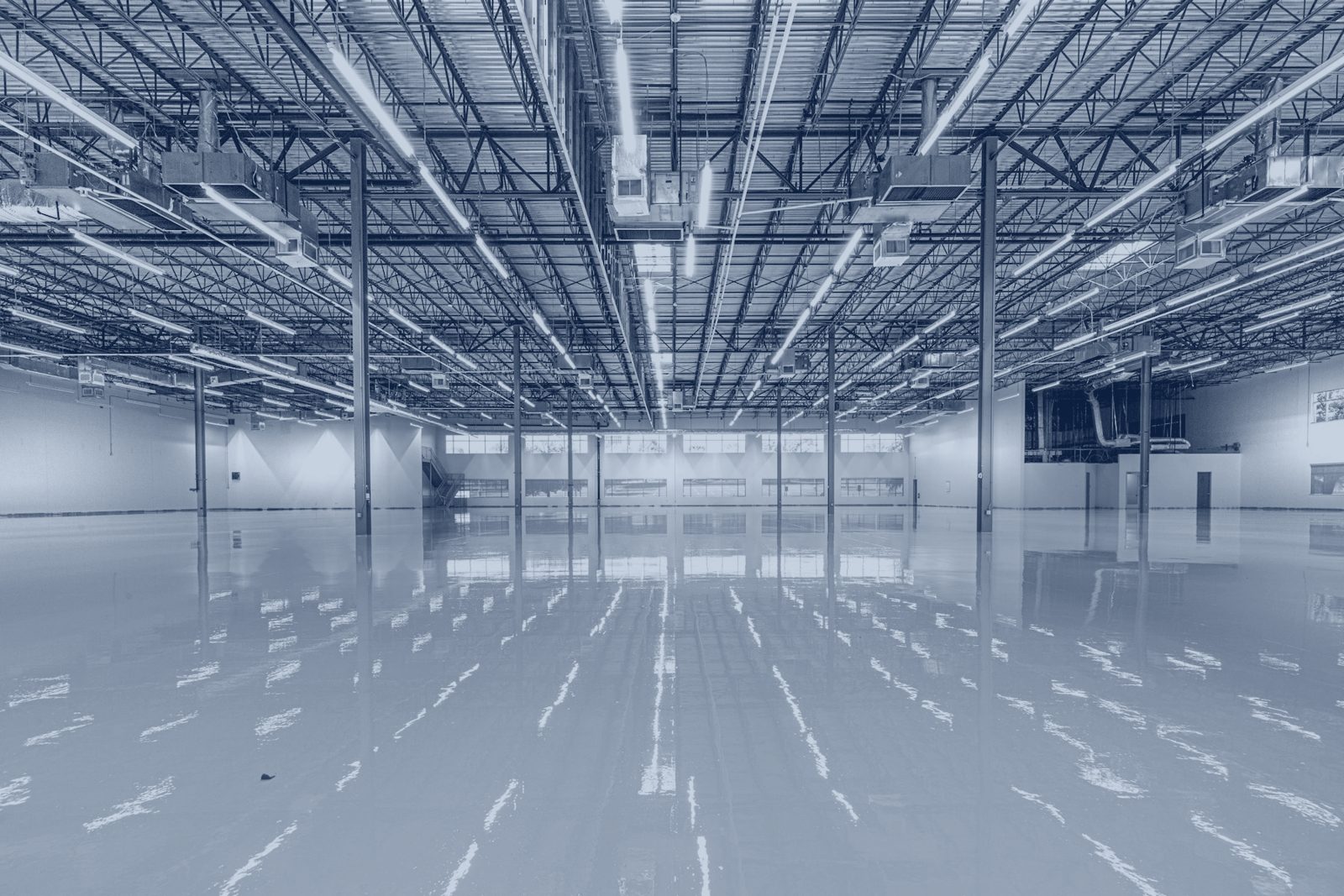 A bright, empty warehouse floor under high-bay lighting.